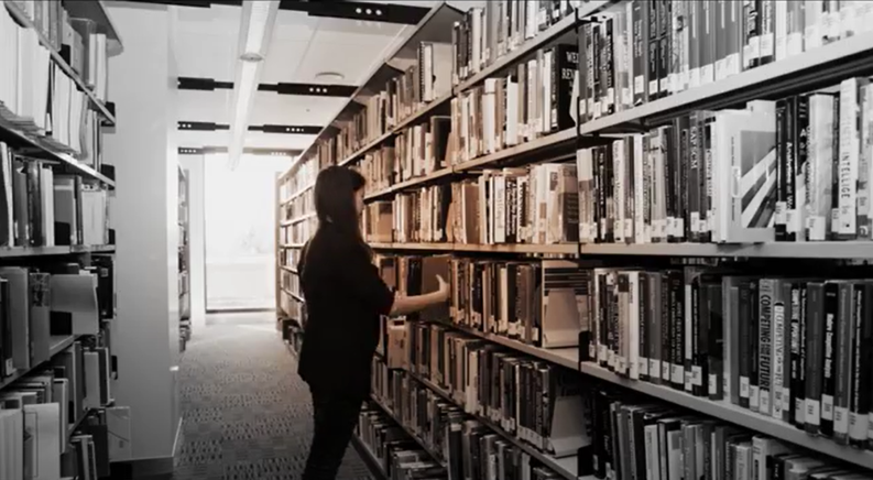 A student studying in a library learning environment